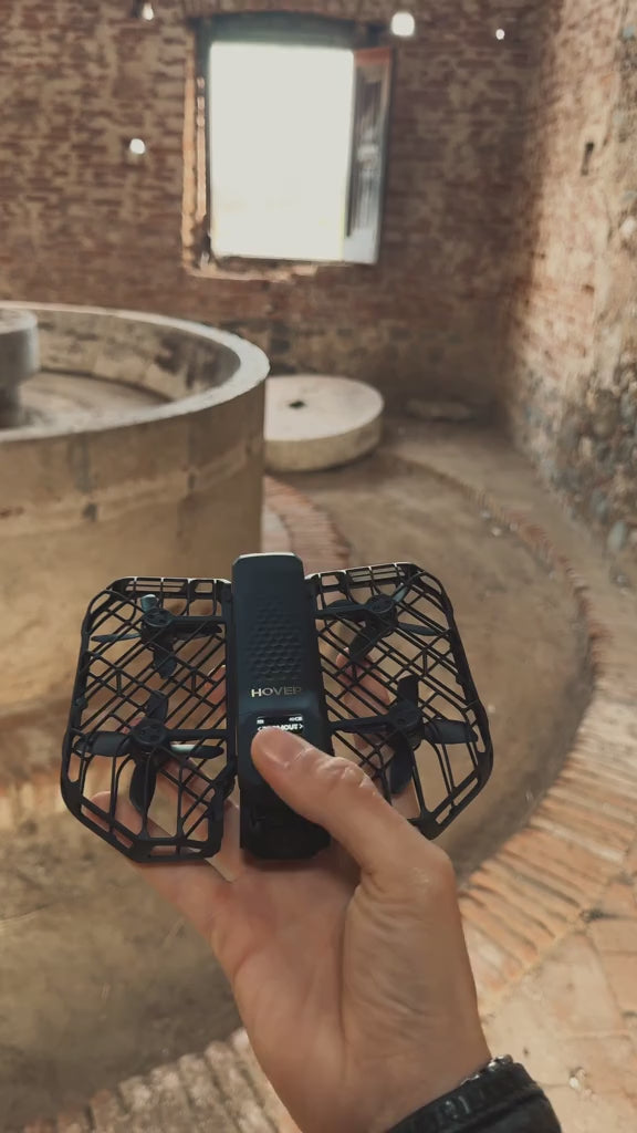 HOVERAir X1 ProMAX 8K Action Flying Camera Drone shown folded and ready for adventure filming. The compact flying action camera features 8K video recording, SmoothCapture 2.0 stabilization, and hands-free automatic flight modes. Ideal for travel, sports, and outdoor activities, this lightweight foldable drone delivers cinematic footage from unique perspectives. It follows movement up to 42 KM/H and handles various terrains with OmniTerrain flight capability, including snow and coastal environments. Designed